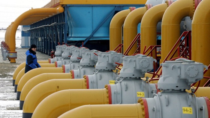 A gas worker walks between pipes in a compressor and distribution station of the Urengoy-Pomary-Uzhgorod gas pipeline