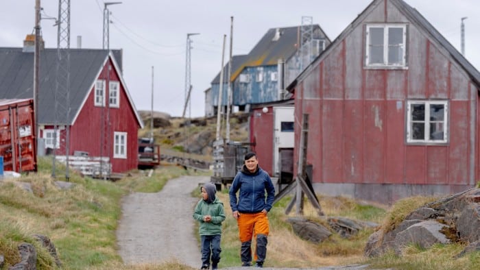 Locals walk in the Attu settlement, Qeqertalik municipality, Greenland