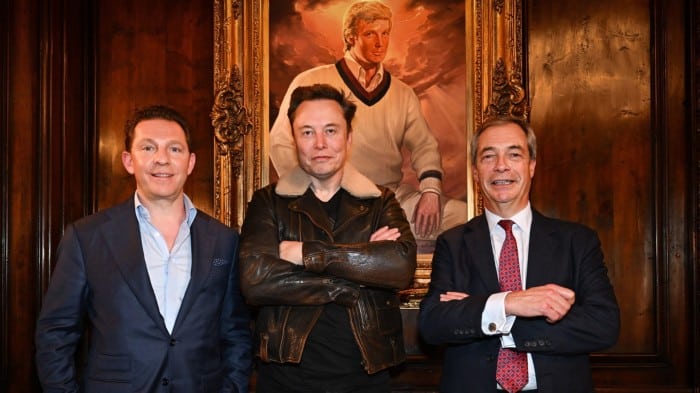 Nigel Farage, Nick Candy  and Elon Musk pose in front of a portrait of Donald Trump at Mar-A-Lago