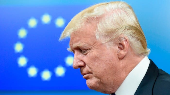 US President Donald Trump in front of an EU flag