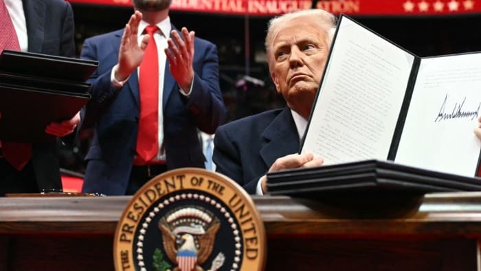 US President Donald Trump holding an order to withdraw the US from the Paris agreement in Capital One Arena, Washington, US on January 20 2025