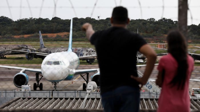 A plane carrying Brazilians deported from US lands Eduardo Gomes International Airport in Manaus, Amazonas state, on January 25