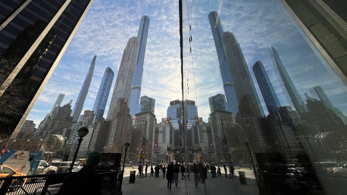 People make their way through the streets of Manhattan during a work day in New York