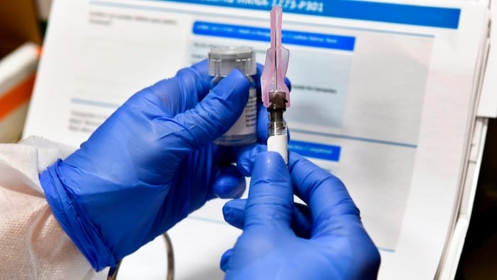 A nurse prepares a shot that is part of a vaccine developed by the National Institutes of Health and Moderna, in Binghamton, New York