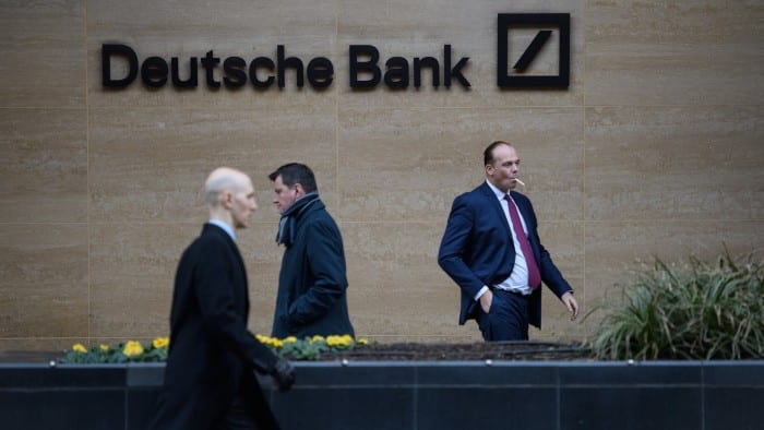 City workers leave Deutsche Bank offices in London, England