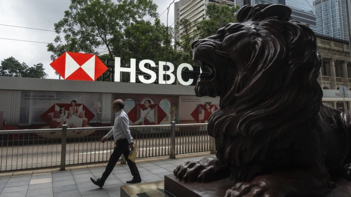 A man walks past HSBC headquarters in Hong Kong