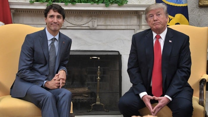 Donald Trump and Justin Trudeau sit during a meeting at the White House