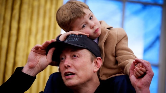 X Musk sits on the shoulders of his father, Tesla and SpaceX CEO Elon Musk