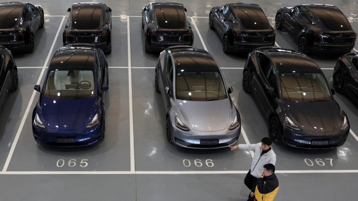 Tesla electric vehicles are parked in a grid at the carmaker's delivery centre in Beijing, China