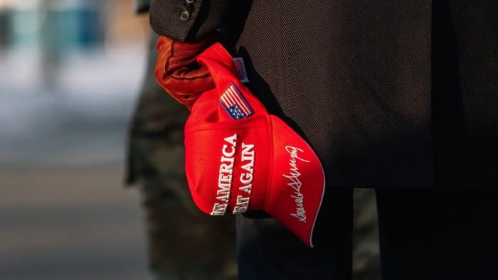 A pro-Trump supporter holding a Maga hat