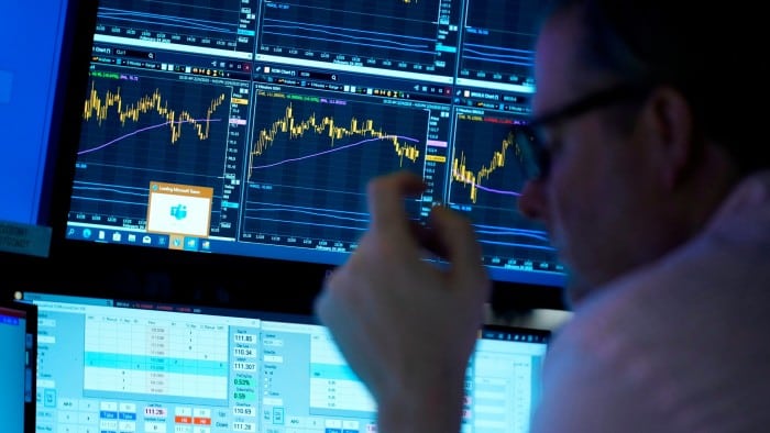 People work on the floor at the New York Stock Exchange