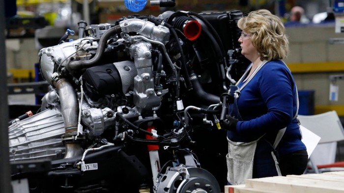 An employee working on the chassis of a pick-up truck at GM’s factory in Flint, Michigan