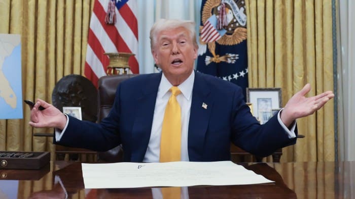 President Donald Trump at his desk in the Oval Office