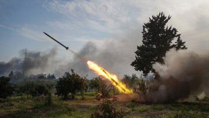 Syrian army forces fire a missile against the fighters linked to Syria’s ousted leader Bashar al-Assad in Latakia province on Friday