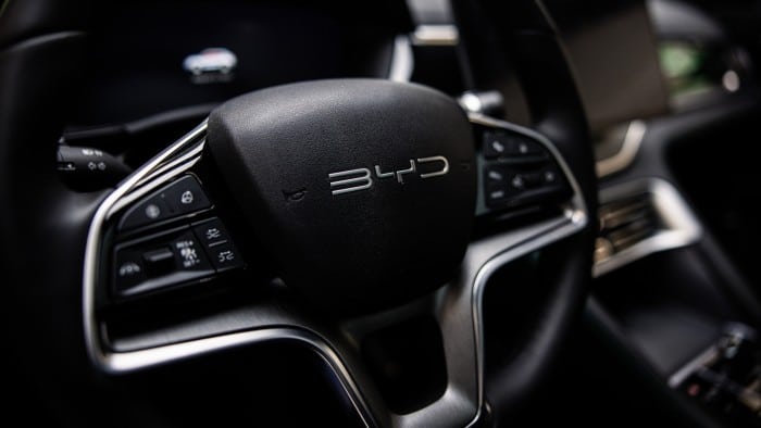 The BYD Co logo on the steering wheel of an electric vehicle