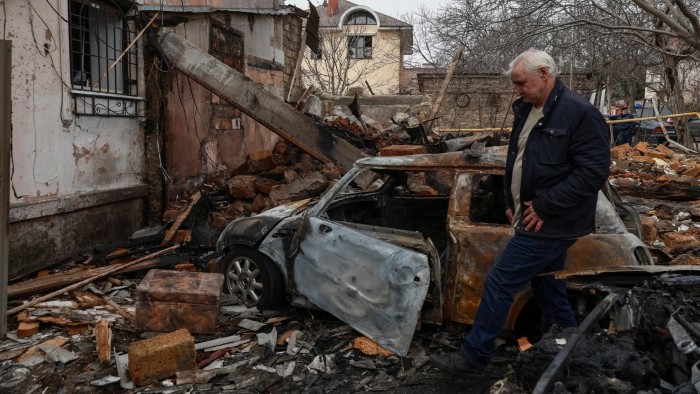 A resident is seen at a site of an apartment building hit by a Russian drone strike, amid Russia’s attack on Ukraine, in Odesa, Ukraine