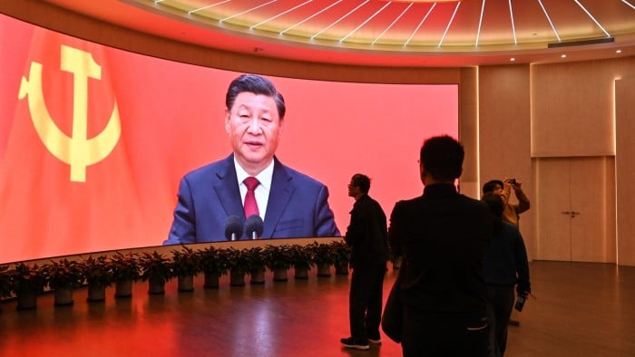 A screen shows images of China’s President Xi Jinping as people visit the Museum of the First National Congress of the Chinese Communist Party in Shanghai