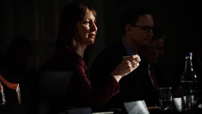 Rachel Reeves sits at a table during a meeting