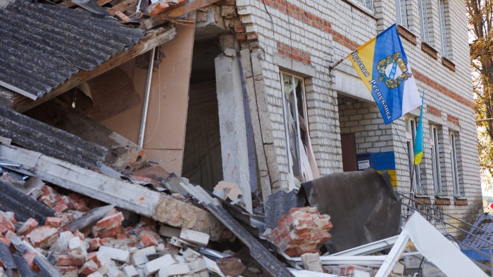 A flag with the coat of arms of the Kursk region placed on a damaged building in the city of Sudzha