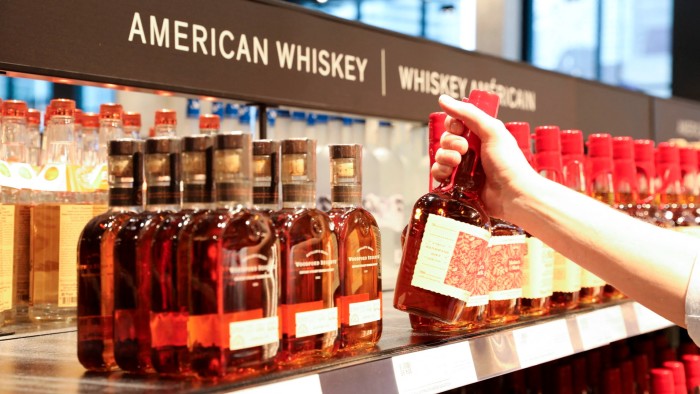 A bottle of US-made liquor is taken off the shelf in Ontario, Canada