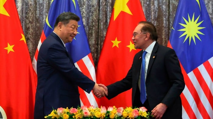 Xi and Anwar shaking hands
