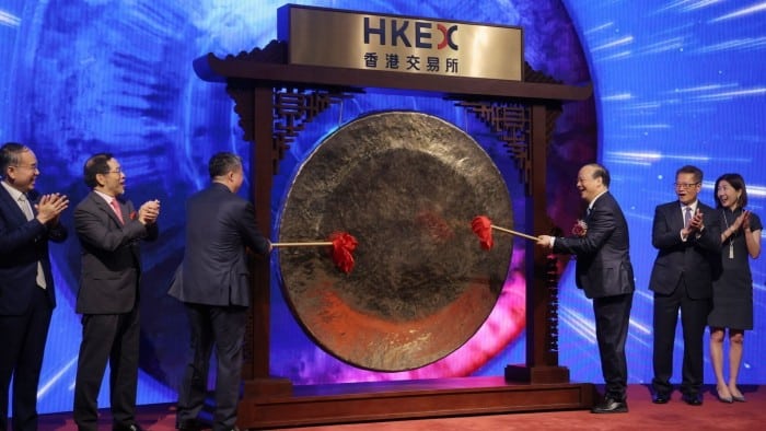 CATL founder Robin Zeng, right, bangs the gong at the Hong Kong stock exchange on May 20 2025 to mark its trading debut