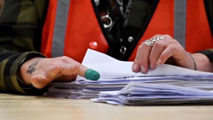 Close-up picture of a pair of hands counting votes