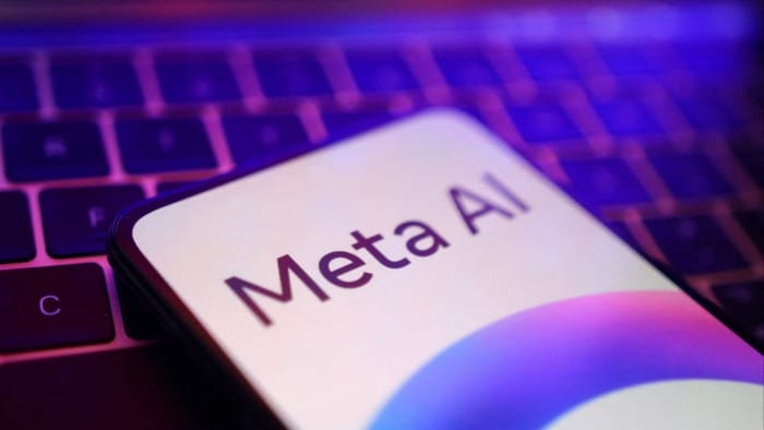 A Meta logo on a mobile phone with a computer keyboard in the background