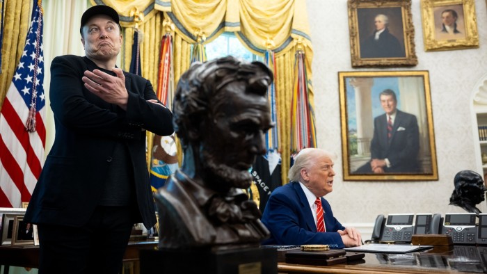 Elon Musk stands beside Donald Trump in the Oval Office during a press conference last month
