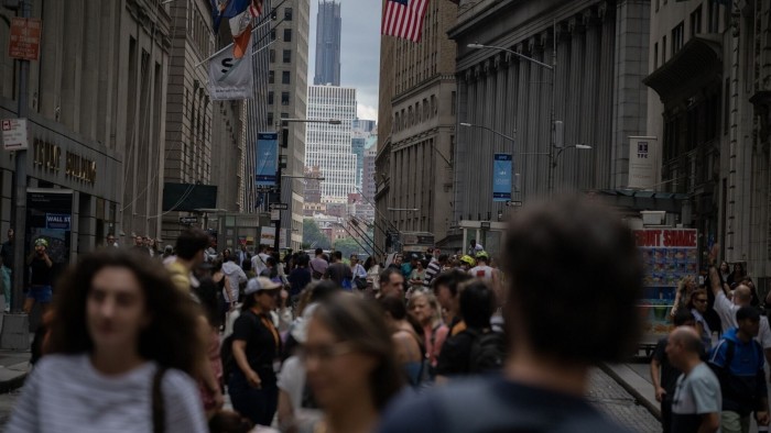 Pedestrians on Wall Street in New York
