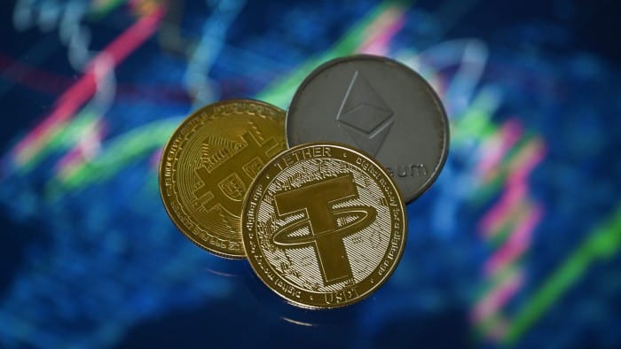 Gold-plated coins representing tether, bitcoin and etherium