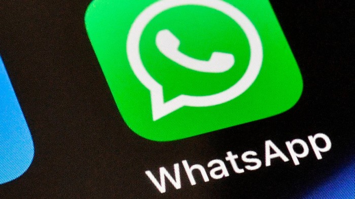 A WhatsApp icon is displayed on an iPhone