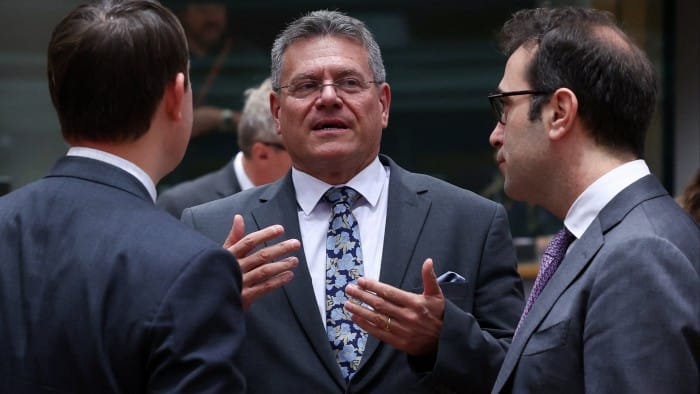 EU trade commissioner Maroš Šefčovič talking to two other ministers in Brussels