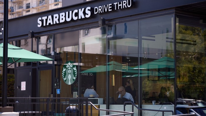 People sit inside a Starbucks in Los Angeles