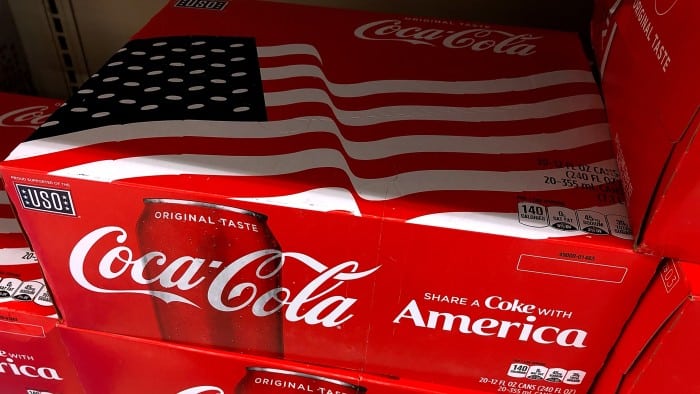 Cases of Coca-Cola are displayed on a grocery store shelf on July 25, 2018