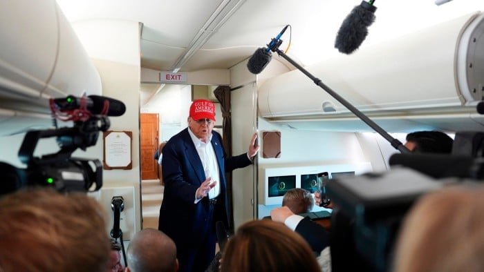 Donald Trump talks with reporters on Air Force One