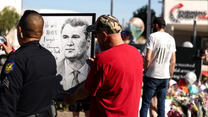 People gather at a makeshift memorial for activist and Turning Point USA Founder Charlie Kirk outside its organisation’s headquarters in Phoenix, Arizona, on September 14